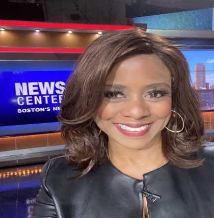 Richardson wearing black leather jacket and wearing golden earrings.